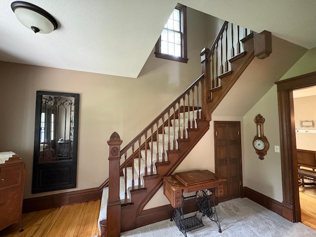 1710 Maple Ave, Benson, MN 56215 - foyer featuring baseboards, stairway, wood finished floors, and lofted ceiling
