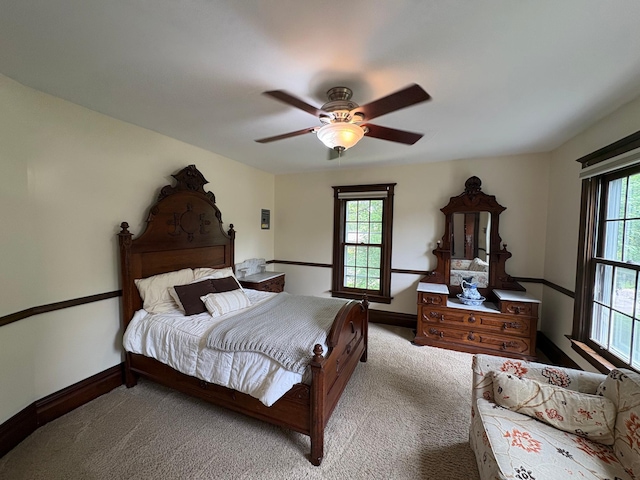 1710 Maple Ave, Benson, MN 56215 - bedroom with multiple windows, carpet flooring, baseboards, and a ceiling fan