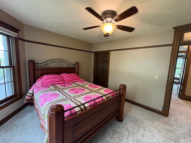 1710 Maple Ave, Benson, MN 56215 - bedroom featuring multiple windows, light carpet, and baseboards