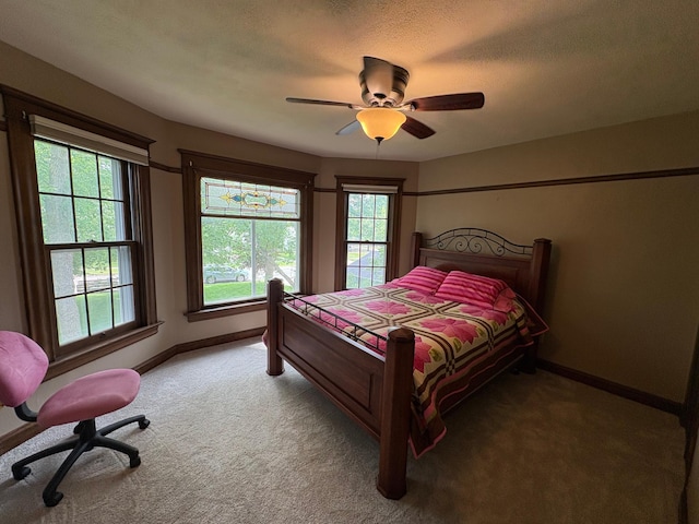 1710 Maple Ave, Benson, MN 56215 - bedroom featuring light carpet, baseboards, a ceiling fan, and a textured ceiling