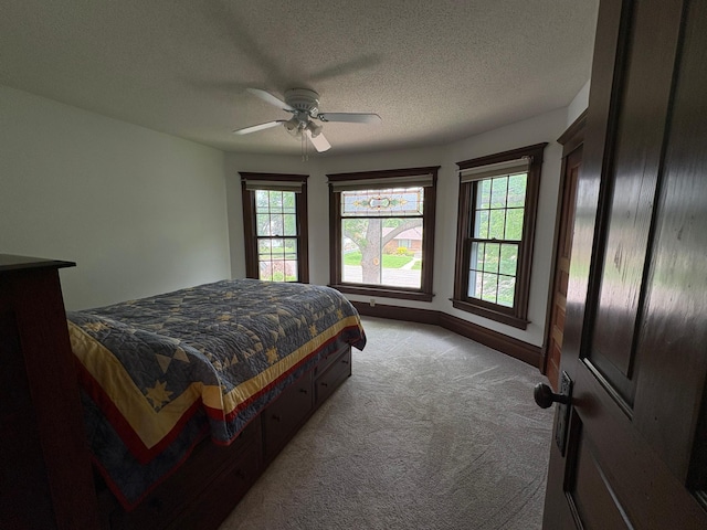 1710 Maple Ave, Benson, MN 56215 - carpeted bedroom with a ceiling fan, baseboards, and a textured ceiling
