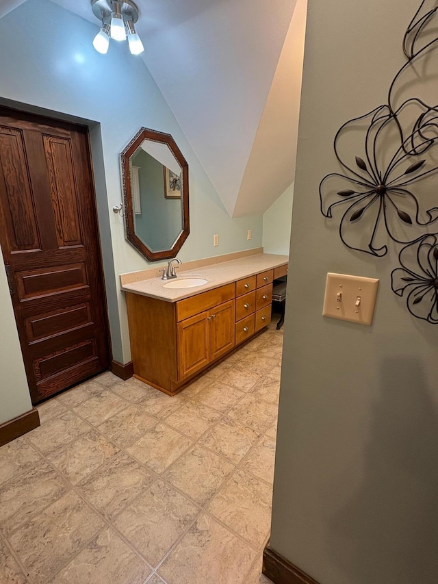 1710 Maple Ave, Benson, MN 56215 - bathroom with vanity, baseboards, and lofted ceiling