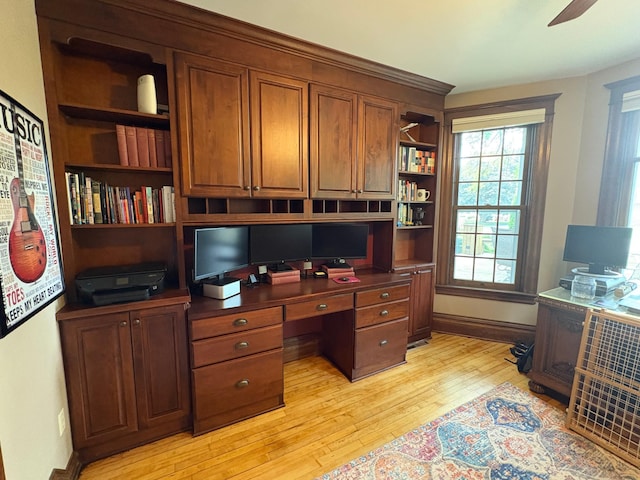 1710 Maple Ave, Benson, MN 56215 - office area with light wood-style floors, built in study area, a ceiling fan, and baseboards