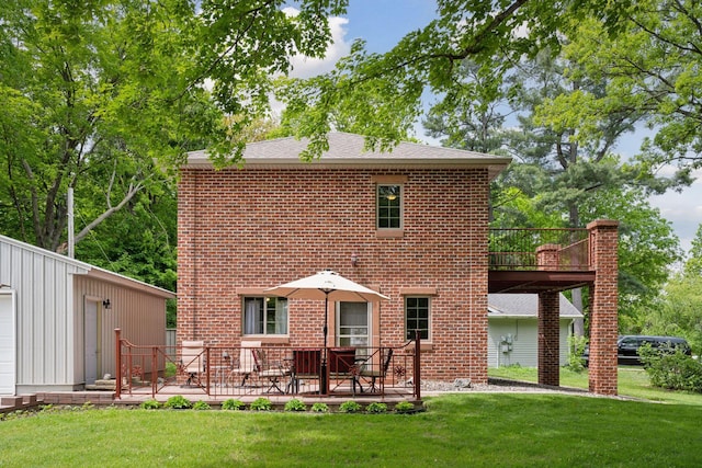 501 Lakeshore Blvd W, Onamia, MN 56359 - rear view of property with a yard, brick siding, and a wooden deck