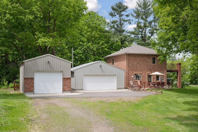 501 Lakeshore Blvd W, Onamia, MN 56359 - view of home's exterior with a garage, an outdoor structure, brick siding, a lawn, and a deck