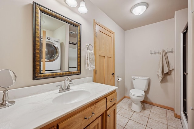 501 Lakeshore Blvd W, Onamia, MN 56359 - bathroom featuring washer / dryer, vanity, tile patterned flooring, toilet, and baseboards