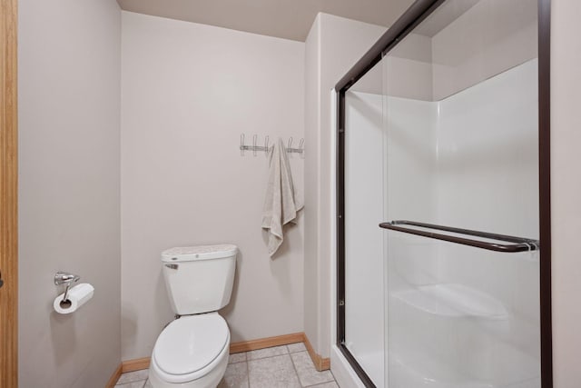 501 Lakeshore Blvd W, Onamia, MN 56359 - bathroom featuring toilet, baseboards, a shower stall, and tile patterned floors