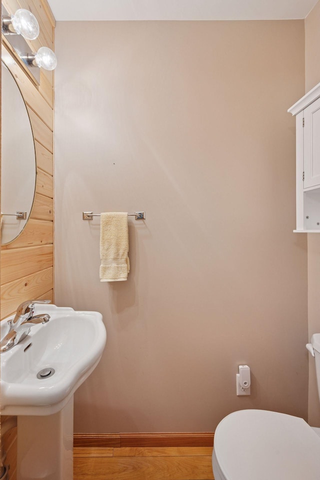 501 Lakeshore Blvd W, Onamia, MN 56359 - half bath featuring toilet, wood finished floors, and baseboards