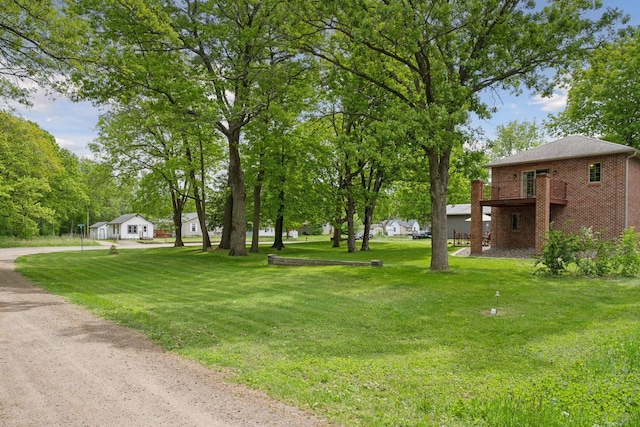 501 Lakeshore Blvd W, Onamia, MN 56359 - view of grassy yard with driveway and a garage