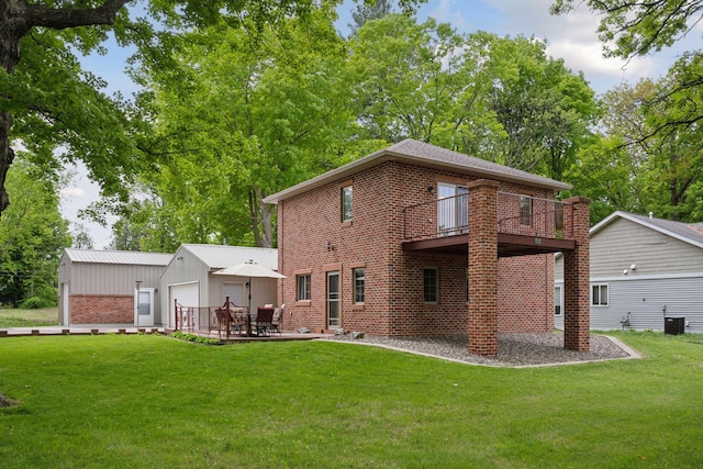 501 Lakeshore Blvd W, Onamia, MN 56359 - rear view of house with brick siding, a yard, cooling unit, a patio area, and an outdoor structure