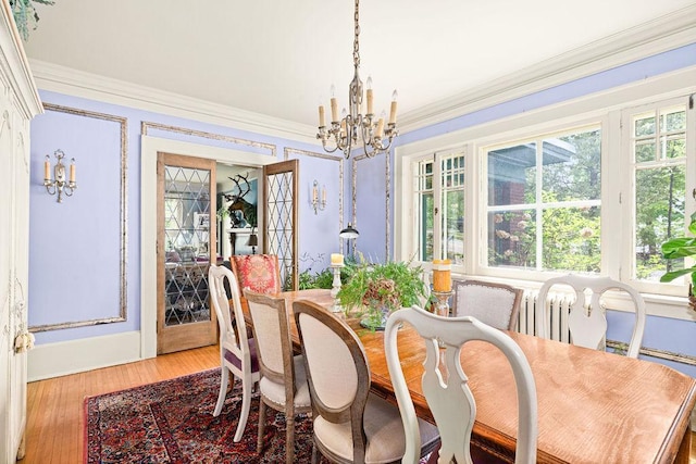 2401 5th St, Duluth, MN 55812 - dining area with a chandelier, light wood finished floors, crown molding, and baseboards