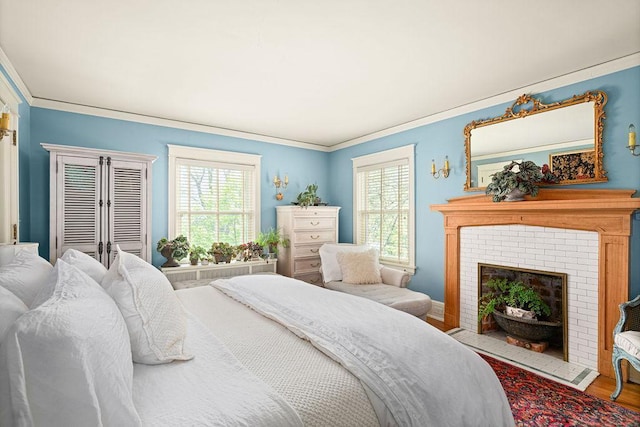 2401 5th St, Duluth, MN 55812 - bedroom with ornamental molding, multiple windows, wood finished floors, and a fireplace