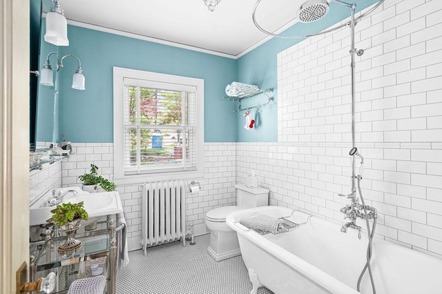 2401 5th St, Duluth, MN 55812 - full bathroom with radiator heating unit, a freestanding tub, tile walls, tile patterned floors, and wainscoting