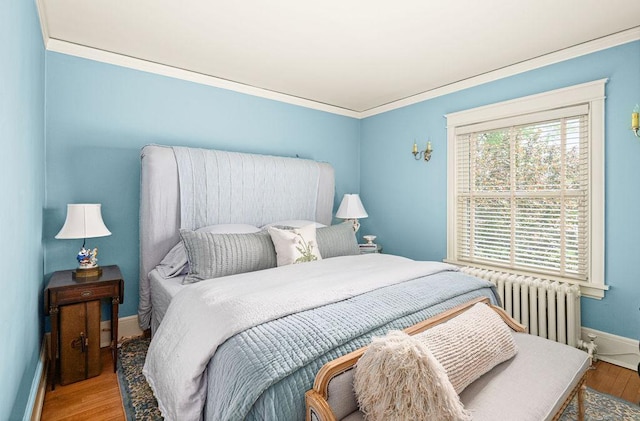 2401 5th St, Duluth, MN 55812 - bedroom with radiator, wood finished floors, baseboards, and ornamental molding