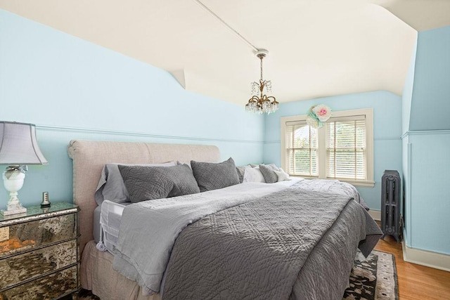 2401 5th St, Duluth, MN 55812 - bedroom with lofted ceiling, light wood-style floors, and a chandelier