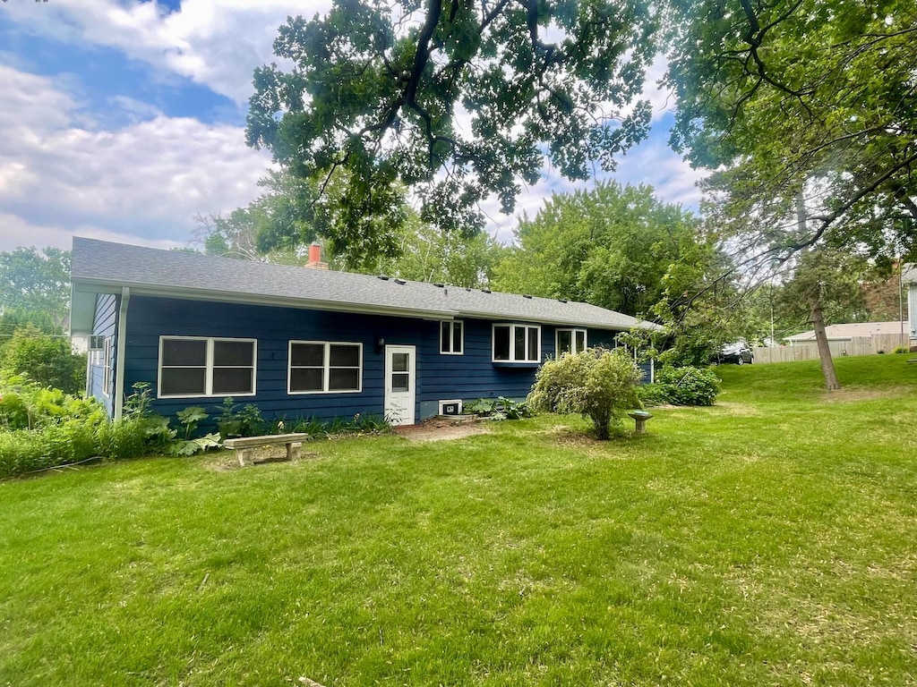 1121 Ramsey St W, Stillwater, MN 55082 - rear view of property with a lawn and a chimney