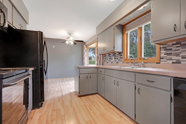 1121 Ramsey St W, Stillwater, MN 55082 - kitchen featuring black appliances, gray cabinetry, ceiling fan, and tasteful backsplash