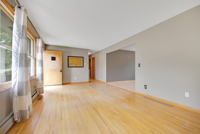1121 Ramsey St W, Stillwater, MN 55082 - unfurnished room featuring baseboard heating and light wood-style floors
