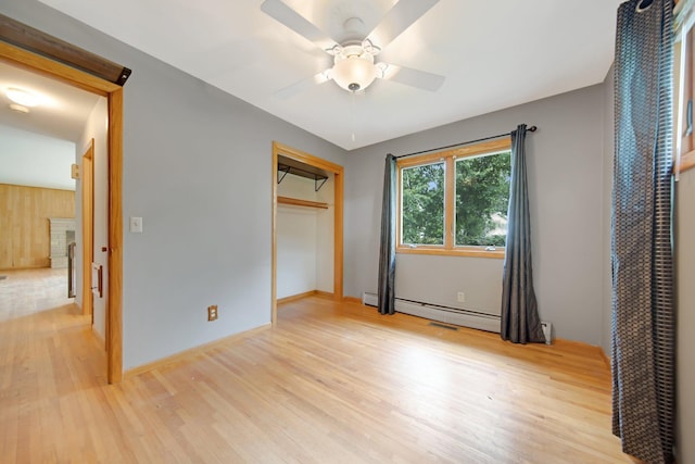 1121 Ramsey St W, Stillwater, MN 55082 - unfurnished bedroom with light wood-style flooring, baseboard heating, and a closet