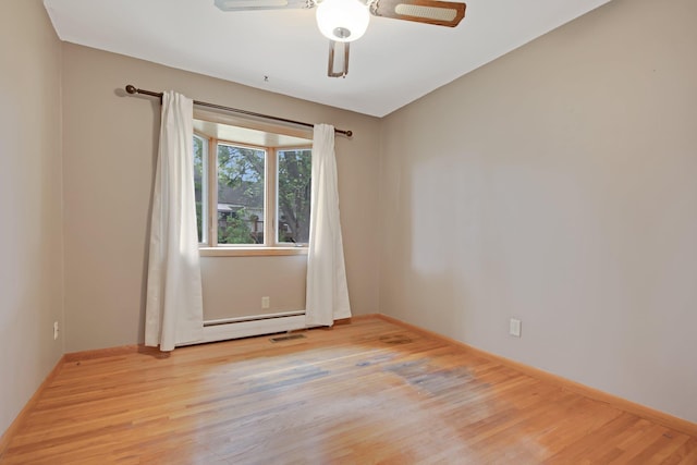 1121 Ramsey St W, Stillwater, MN 55082 - unfurnished room featuring light wood-style floors, a baseboard heating unit, and ceiling fan