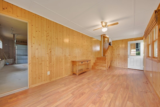 1121 Ramsey St W, Stillwater, MN 55082 - spare room with stairs, wood walls, wood finished floors, healthy amount of natural light, and a ceiling fan