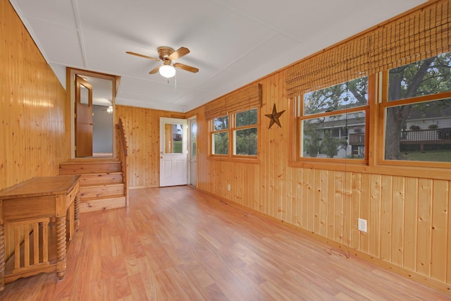 1121 Ramsey St W, Stillwater, MN 55082 - unfurnished room featuring healthy amount of natural light, ceiling fan, wood finished floors, and wooden walls