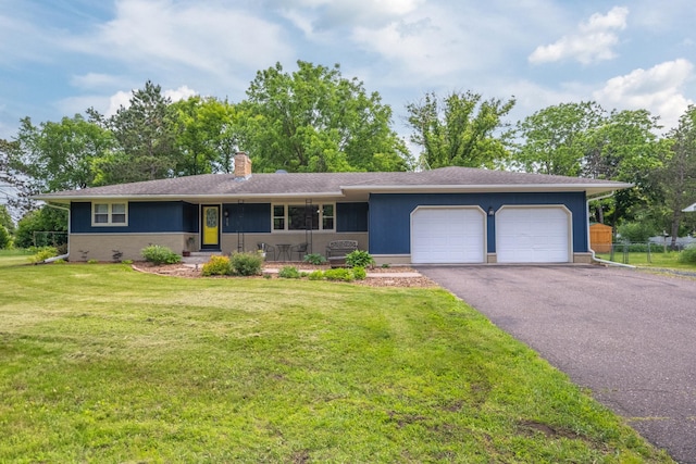 615 Eisenhower Dr, Saint Croix Falls, WI 54024 - single story home with a garage, a chimney, asphalt driveway, and a front yard
