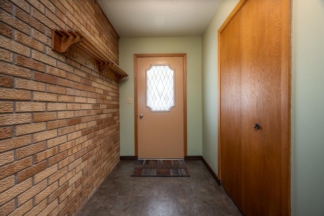615 Eisenhower Dr, Saint Croix Falls, WI 54024 - doorway with brick wall and baseboards