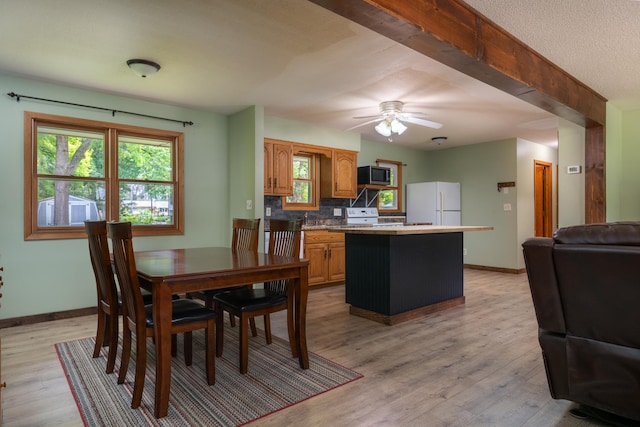615 Eisenhower Dr, Saint Croix Falls, WI 54024 - dining area with baseboards, light wood-style floors, and ceiling fan