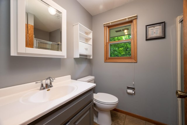 615 Eisenhower Dr, Saint Croix Falls, WI 54024 - full bathroom featuring toilet, vanity, tile patterned floors, baseboards, and a shower