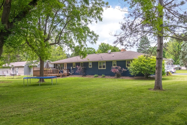 615 Eisenhower Dr, Saint Croix Falls, WI 54024 - back of house featuring a deck, a chimney, a yard, and a trampoline
