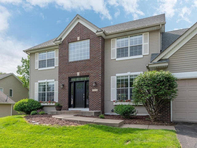 15000 Bridgewater Dr, Savage, MN 55378 - view of front of house with a front lawn, brick siding, and a shingled roof