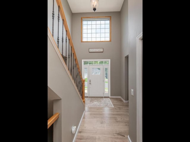 15000 Bridgewater Dr, Savage, MN 55378 - entrance foyer with light wood-style floors, stairs, and a high ceiling