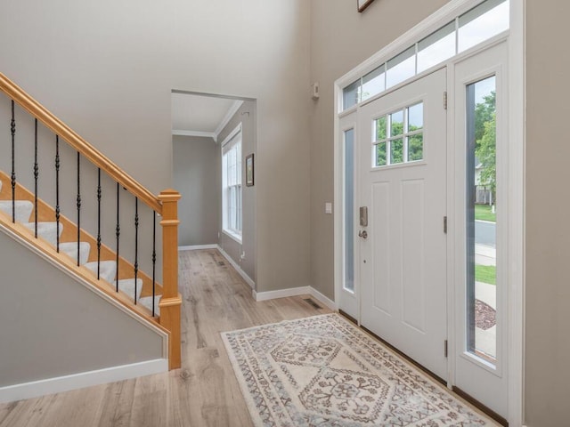 15000 Bridgewater Dr, Savage, MN 55378 - foyer entrance with wood finished floors, crown molding, and stairs