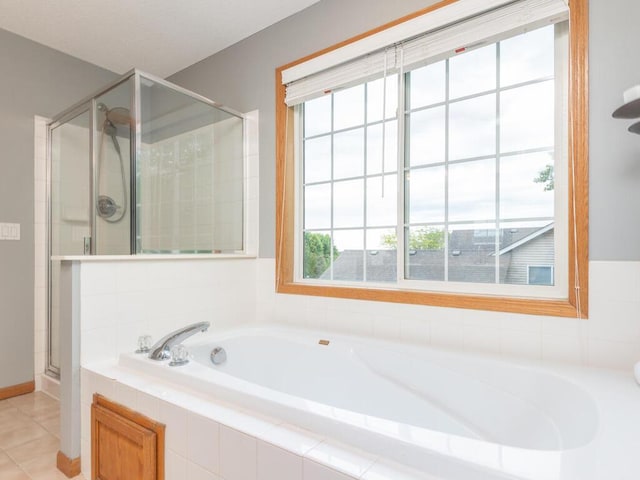 15000 Bridgewater Dr, Savage, MN 55378 - bathroom featuring a garden tub, a stall shower, and tile patterned flooring