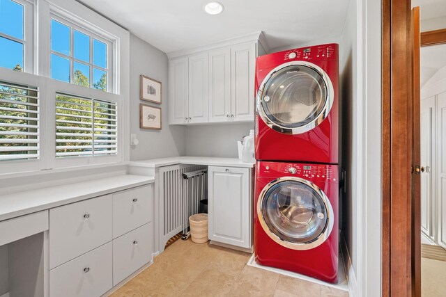 4601 Lake Harriet Pkwy, Minneapolis, MN 55419 - washroom with cabinet space, stacked washer and clothes dryer, recessed lighting, and light tile patterned flooring