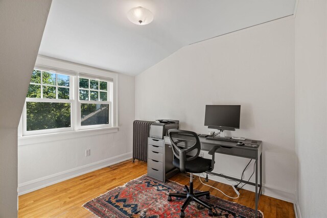 4601 Lake Harriet Pkwy, Minneapolis, MN 55419 - home office with lofted ceiling, wood finished floors, baseboards, and radiator
