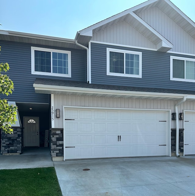 25915 Oriole St, Elko New Market, MN 55054 - view of front of house featuring a garage, concrete driveway, and stone siding