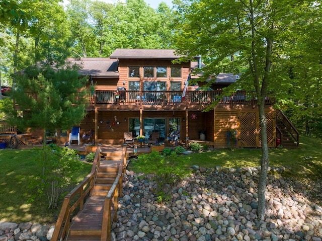 1147 Hillside Ln, Edgewater, WI 54817 - back of house with stairway, a wooden deck, a lawn, and a patio area