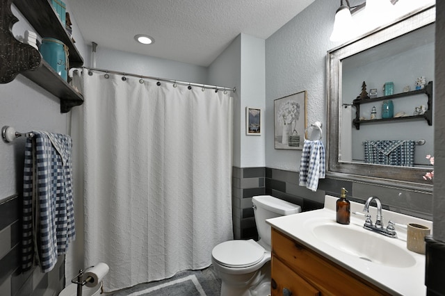 1147 Hillside Ln, Edgewater, WI 54817 - bathroom featuring toilet, a wainscoted wall, a textured ceiling, vanity, and a shower with curtain