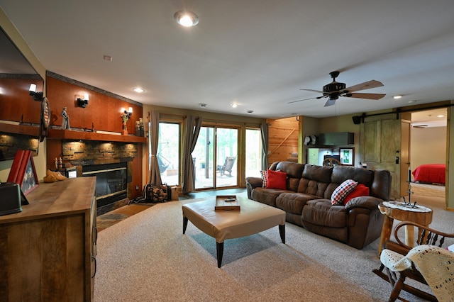 1147 Hillside Ln, Edgewater, WI 54817 - living area featuring a barn door, a fireplace with flush hearth, recessed lighting, a ceiling fan, and carpet flooring