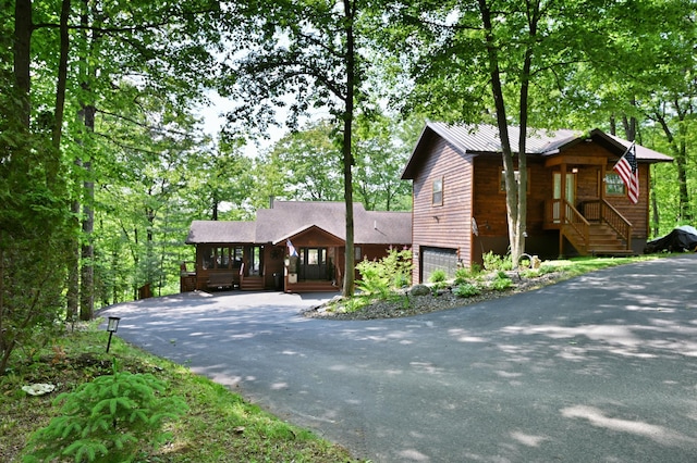 1147 Hillside Ln, Edgewater, WI 54817 - chalet / cabin featuring driveway, an attached garage, and a porch