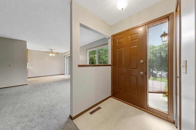 5214 148th St W, Apple Valley, MN 55124 - entrance foyer featuring a textured ceiling, a ceiling fan, and light carpet