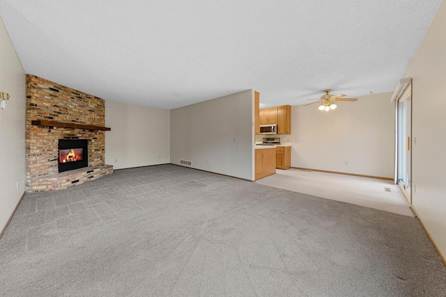 5214 148th St W, Apple Valley, MN 55124 - unfurnished living room with ceiling fan, a fireplace, and light carpet