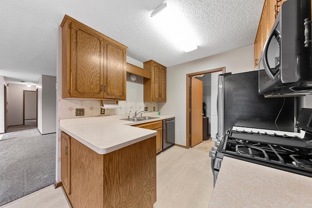 5214 148th St W, Apple Valley, MN 55124 - kitchen featuring stainless steel appliances, light countertops, light wood-type flooring, and a textured ceiling