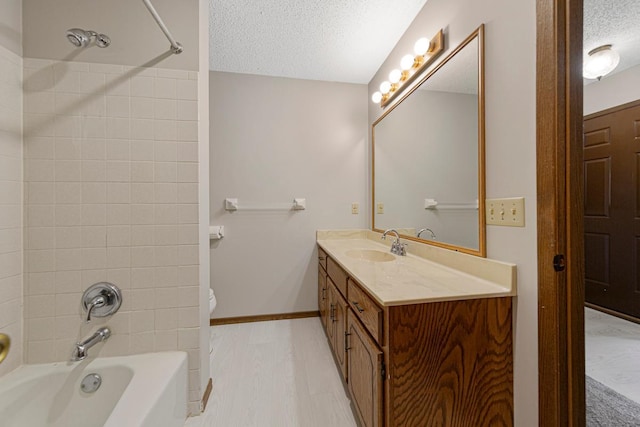 5214 148th St W, Apple Valley, MN 55124 - bathroom with a textured ceiling, vanity, and washtub / shower combination