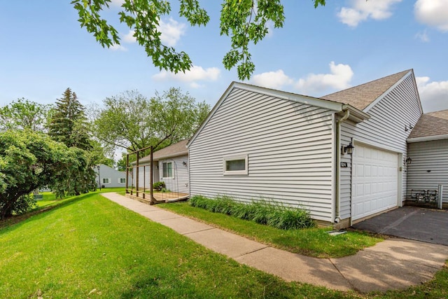 5214 148th St W, Apple Valley, MN 55124 - view of side of property with a yard, roof with shingles, asphalt driveway, and an attached garage