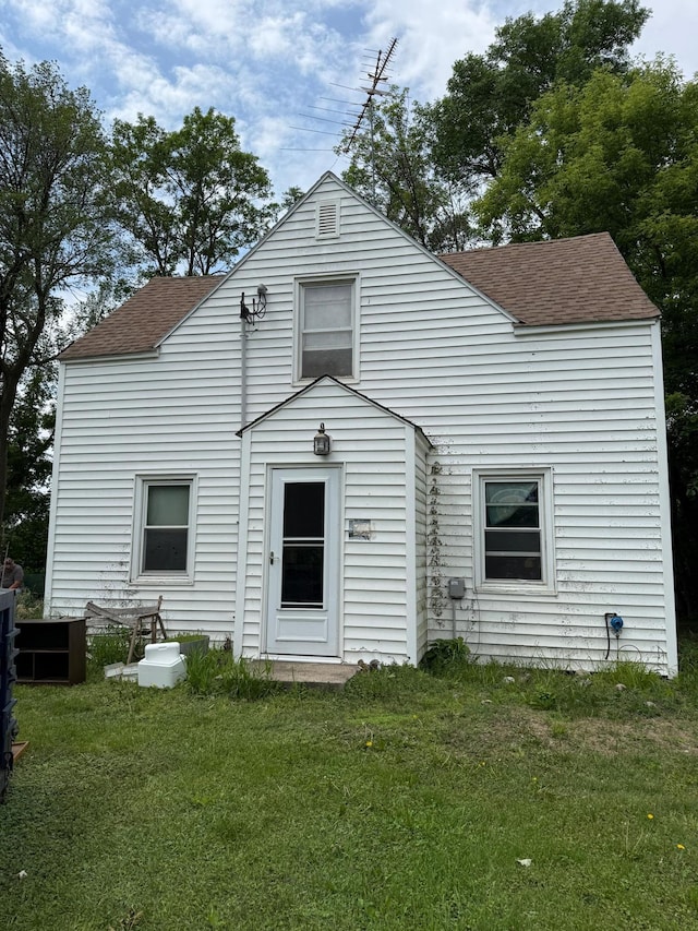 67433 325th St, Watkins, MN 55389 - rear view of property with a shingled roof and a lawn