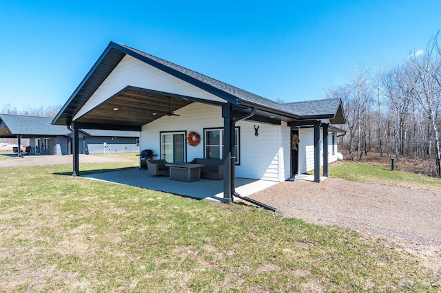 2855 28 11/16 St, Cedar Lake Twp, WI 54817 - view of property exterior with a ceiling fan, a lawn, a patio area, an outdoor hangout area, and roof with shingles