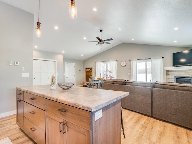 2855 28 11/16 St, Cedar Lake Twp, WI 54817 - kitchen with open floor plan, lofted ceiling, light wood-style flooring, a kitchen island, and a ceiling fan